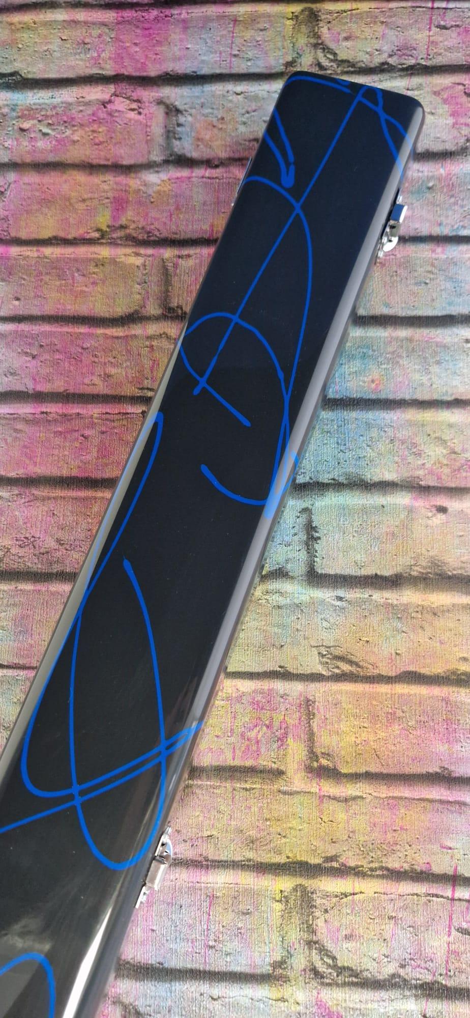 Black rectangular case with blue abstract lines on a colorful brick wall background