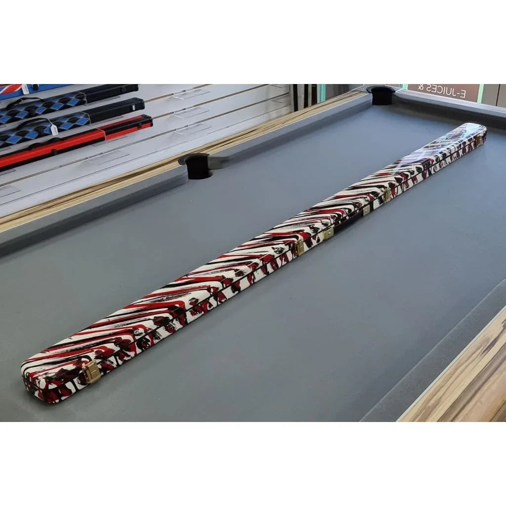 Custom handmade fibreglass resin pool and snooker cue case with red, black, and white pattern on a pool table.