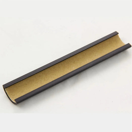 Brown rectangular incense holder with grooved center on a white background